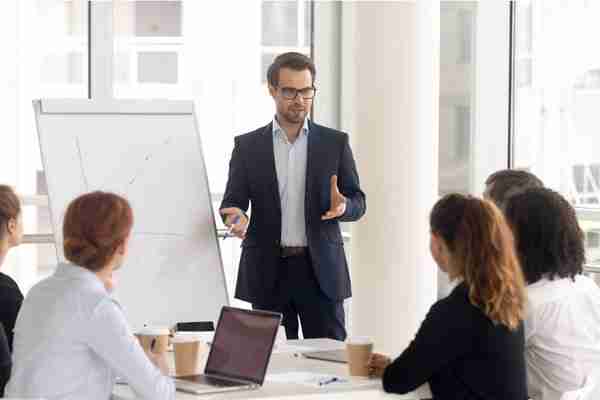 Male business coach speaker in suit give flipchart presentation