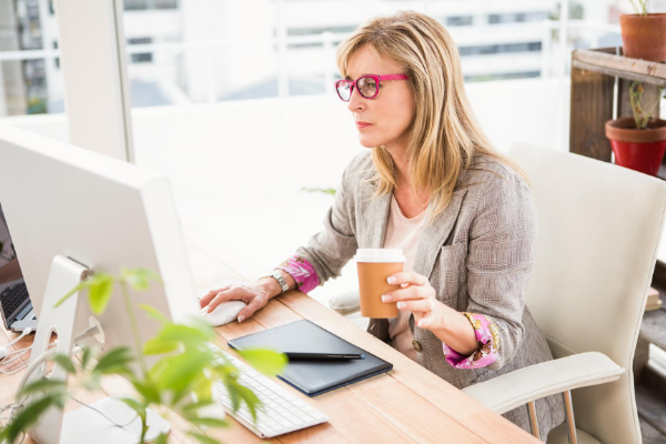 woman-at-computer-desk-benefits-of-attending-seminars-and-workshops Young creative business people meeting best business workshops and seminars